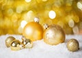 Gold Christmas balls on the shiny background. Very shallow depth of field. Selective focus Royalty Free Stock Photo