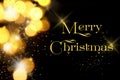 Gold Christmas lights soft focus bokeh background with Merry Christmas Royalty Free Stock Photo