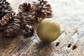 Gold Christmas Ornament Pinecones on wooden background