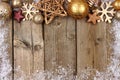 Gold Christmas ornament top border with snow frame on wood Royalty Free Stock Photo