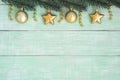 Gold christmas ornaments hanging on fir branch over green vintage backgeound Royalty Free Stock Photo