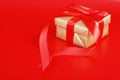 Gold christmas present on red Royalty Free Stock Photo