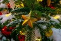 Gold Christmas star christmas tree background of de-focused lights with decorated tree