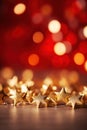 Gold christmas stars with christmas glowing golden red on a red blurred bokeh background Royalty Free Stock Photo