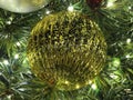 Gold Christmas Tree Ball Ornament and Lights Royalty Free Stock Photo