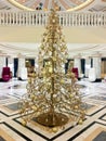 Gold christmas tree indoors. Curious and intresting decoration