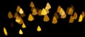 Gold Christmas tree lights garland in defocus on a black background. Yellow circles bokeh Royalty Free Stock Photo