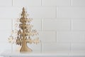 Gold Christmas tree and white wall background