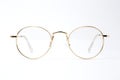 Gold classic round glasses on white background