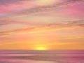 Beautiful gold  pink sunset at sea  water reflection sun light on  gold yellow  clouds sky  nature background Royalty Free Stock Photo