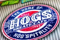 Gold Coast Australia Oval sign for Hogs Breath Cafe on corregated steel wall -Closeup