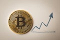 Gold coin Bitcoin and up arrow