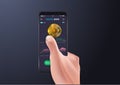 Gold coin and donate button on smartphone screen. Hand holds smartphone, finger touches screen.