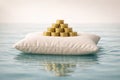 Gold coin pyramid resting on a soft pillow floating on calm water with subtle reflections Royalty Free Stock Photo