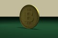 Gold coin with the symbol of digital crypto currency bitcoin stands on the end on a green table, 3d rendering.