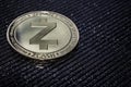 The Gold coin of the zcash cryptocurrency on a gray background