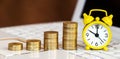 Gold coins and alarm clock on a laptop, online investment banner Royalty Free Stock Photo