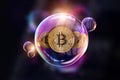 Gold Coins Bitcoin in a soap bubble. The concept of instability of the crypto currency, electronic money, the burning of the