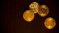 Gold coins of bitcoins on an office table on a dark background Royalty Free Stock Photo