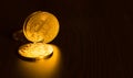 Gold coins of bitcoins on an office table on a dark background Royalty Free Stock Photo