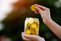 gold coins in a glass jar gold savings concept finance banking financial planning financial stability