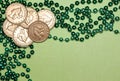 Gold Coins and Green Beads Flat Lay on Light Green Background St. Patrick`s Day Theme