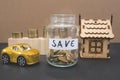 Gold coins in a jar with money. Real estate investment concept, home insurance, auto loan. Housing and car savings plans Royalty Free Stock Photo