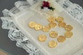 Gold coins on lace mat Royalty Free Stock Photo