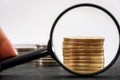 Gold coins through a magnifier. Close-up.