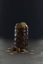 Gold coins in a piggy bank on a black background, growth in savings. Economic crisis and saving money. Donation to a charity fund Royalty Free Stock Photo