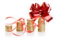 Gold coins with a red gift bow.