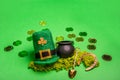 Gold coins scattered on green isolated background, St. Patricks hat, leprechaun kettle, horseshoe Royalty Free Stock Photo