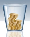 Gold coins are seen inside a glass tumbler