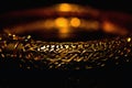 Gold color bracelet isolated on black background Royalty Free Stock Photo