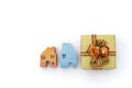 Gold color gift box with wooden miniature house