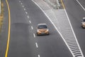 Gold color Honda jazz or Honda fit driving fast on trans jawa highway blurry in motion Royalty Free Stock Photo