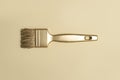 Gold color paintbrush on beige background. Horizontal creative theme poster, greeting cards, headers, website and app