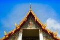 A gold color roof of buddha temple is shading by sunshine under clear blue sky Royalty Free Stock Photo