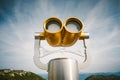 Gold color tourist binoculars working with money