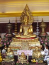 Gold-colored Buddha and monks statue in Buddhist temple Royalty Free Stock Photo