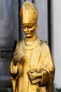 Gold colored bust of Aloysius Stepinac in front of Pauline monastery