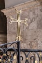 Gold colored cross sign at St. James Armenian Orthodox Cathedral during a service in Jerusalem Royalty Free Stock Photo