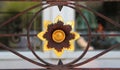 Gold colored flower, rusty ornamental ironwork Royalty Free Stock Photo