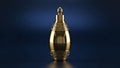 Gold metallic perfume atomizer isolated on a deep navy background Royalty Free Stock Photo