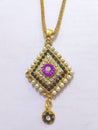 Gold-colored necklace with colored pendant
