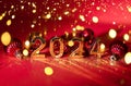 2024 gold colored numbers and glittering confetti on a vivid bright red background