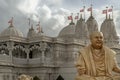 The gold colored statue of spiritual leader holiness pramukh swami maharaj front of Neasden temple