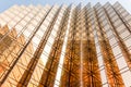 Gold colour office building tower facade in business center Royalty Free Stock Photo