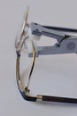 Gold coloured female eyeglass metal frame eyepiece adjusted with eyewire forming pliers