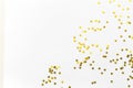 Gold confetti and stars and sparkles on a light background. Top view, flat lay. Copy text. Bright and festive background. For
